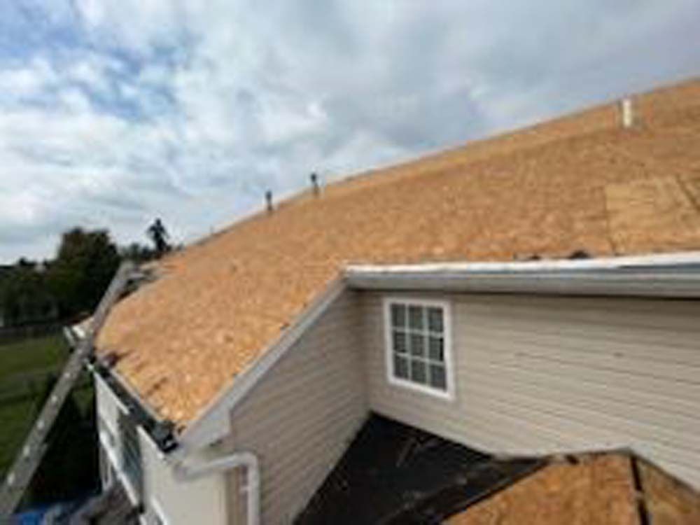 A house with a roof that is being installed.