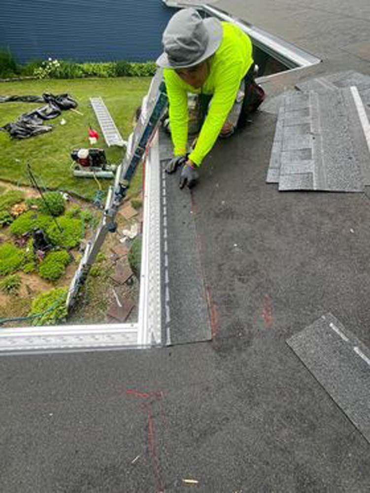 A man is working on a roof with a ladder.