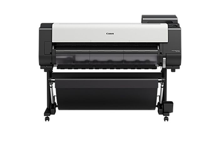 Canon large-format printer, black and white, on a stand with a paper collection basket.