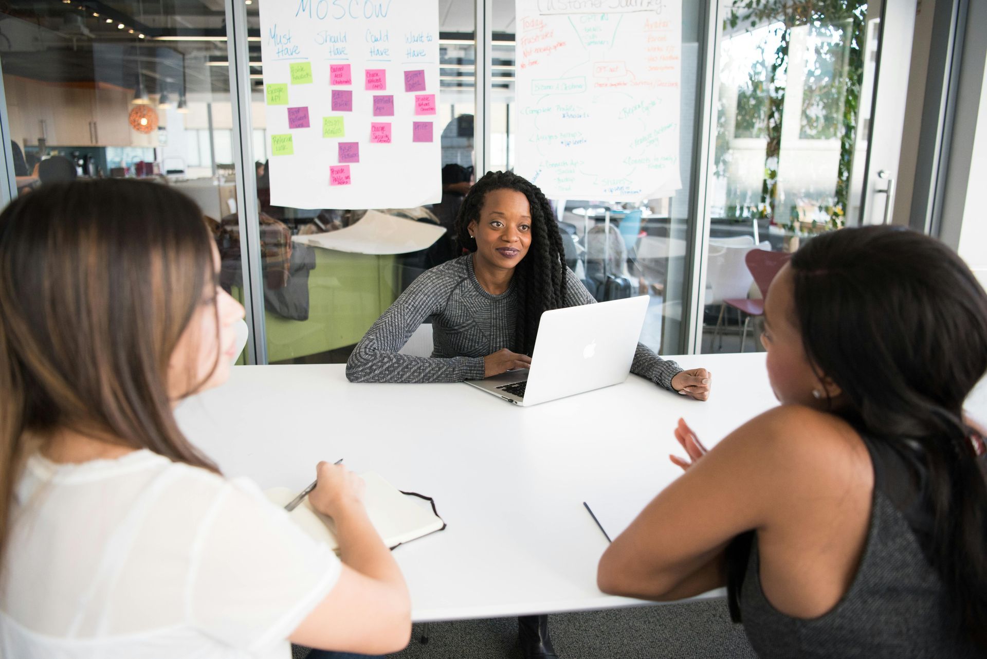 Three women in a meeting.
