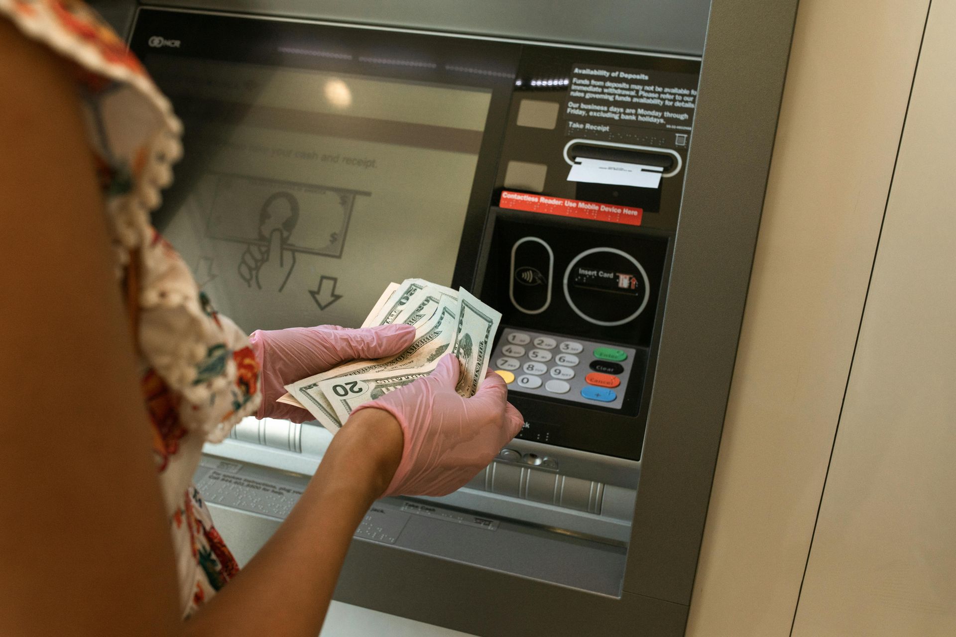 A woman depositing money at the atm.