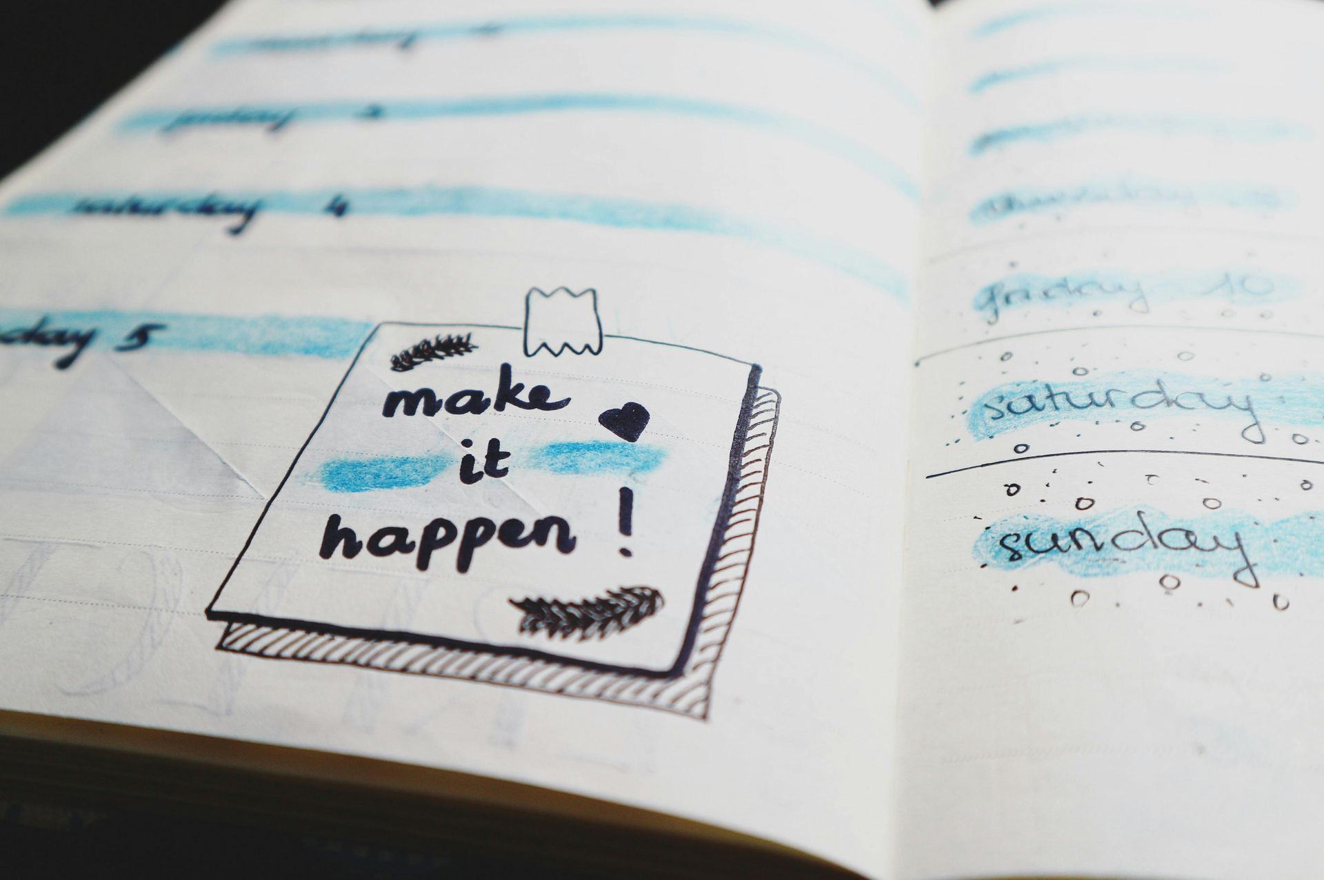 A planner with a 'make it happen' drawing on it.