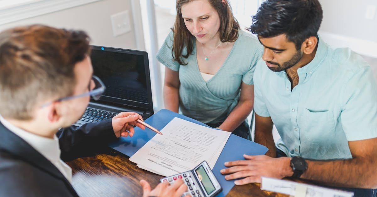 A couple speaking with a financial advisor.