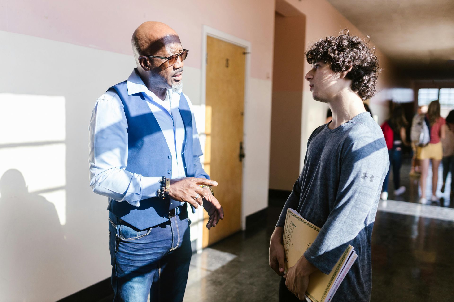An adult talking to a teenager.