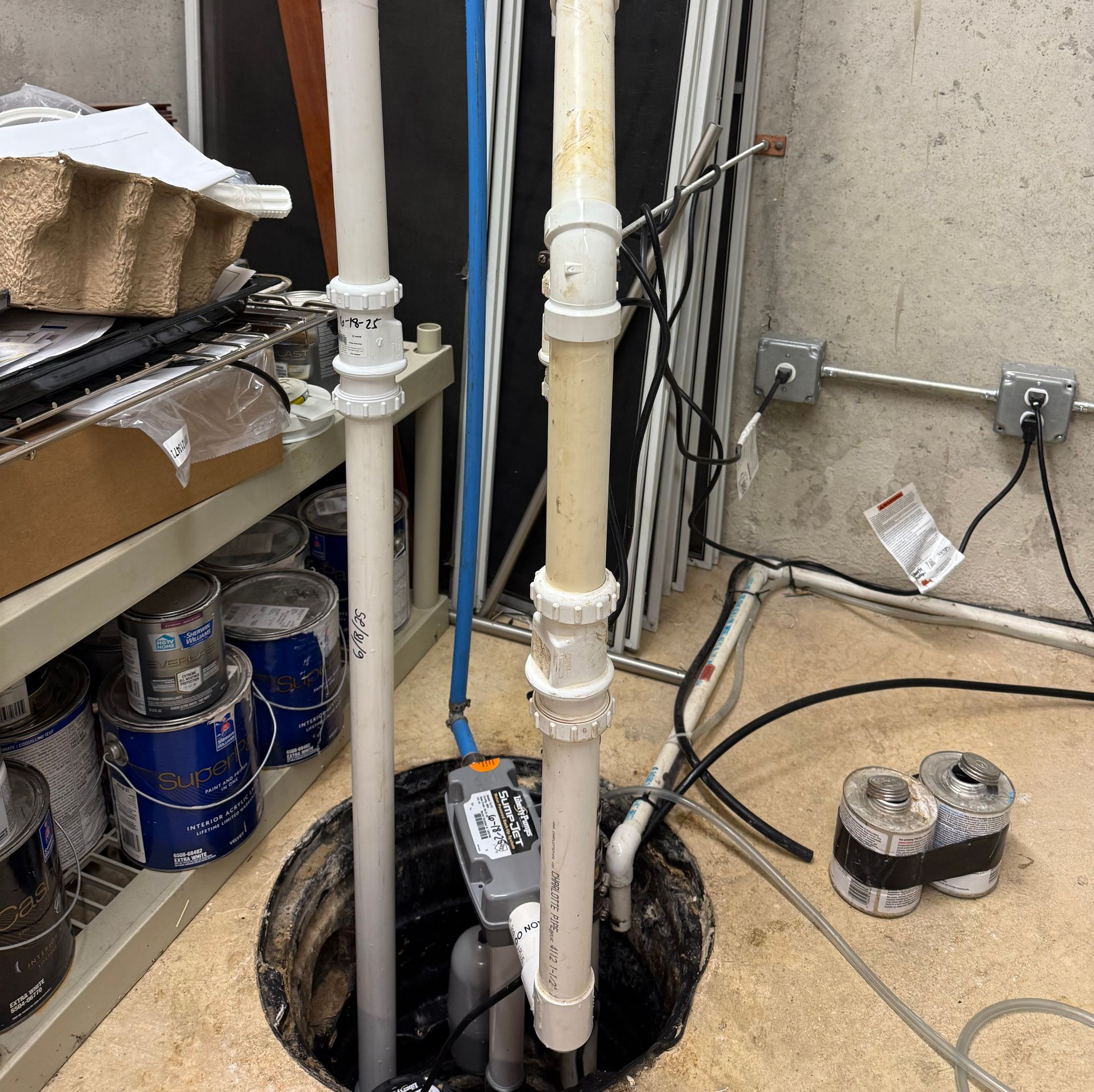 A plumber using tools to perform a water heater repair.