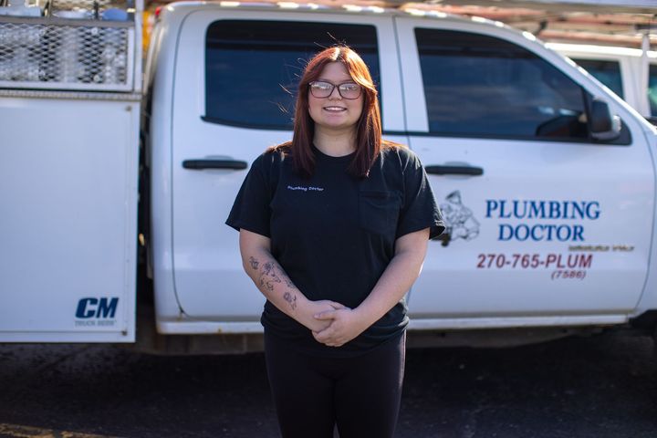 Licensed technician providing plumbing services in a residential home.