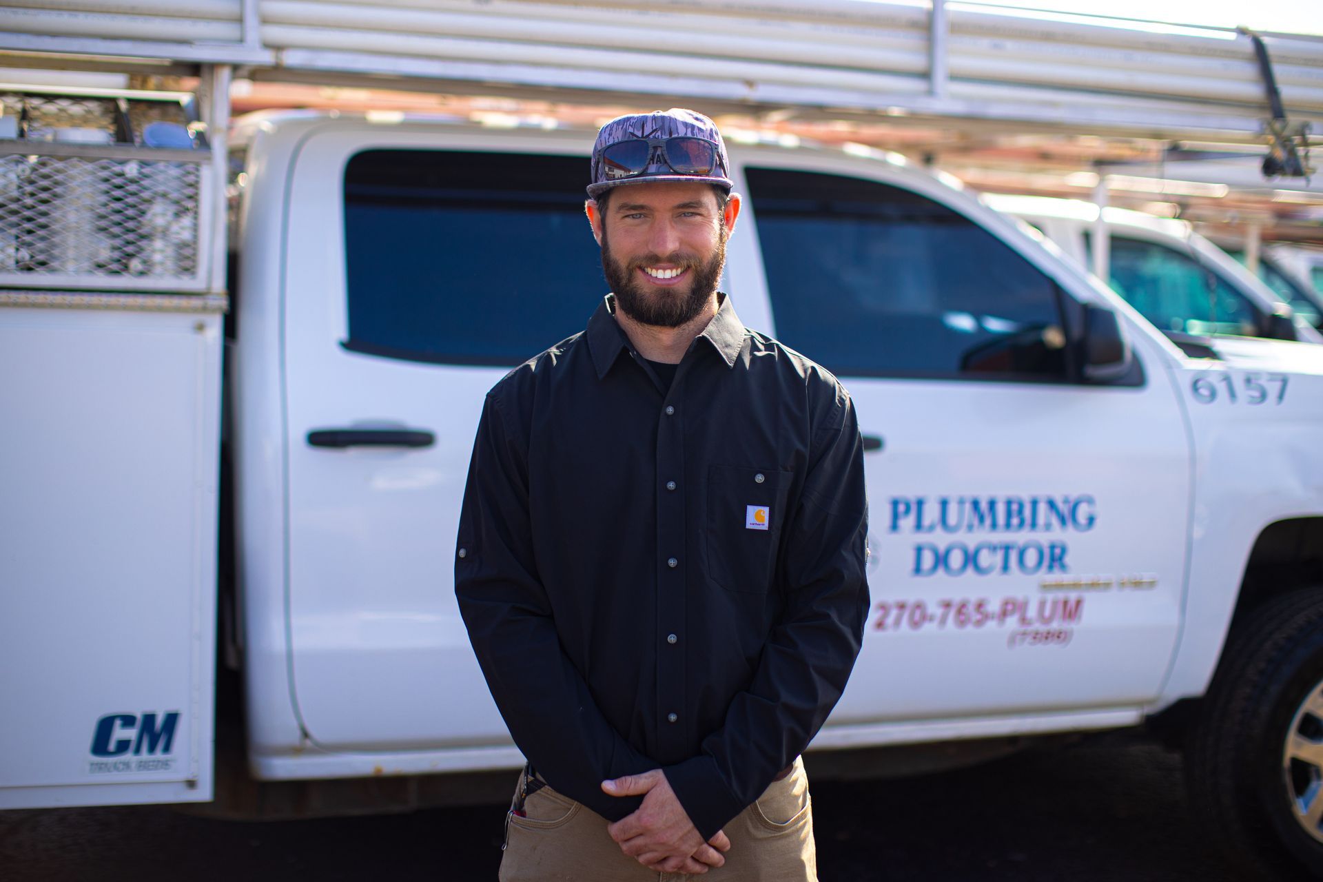 Man standing in front of a white truck with 