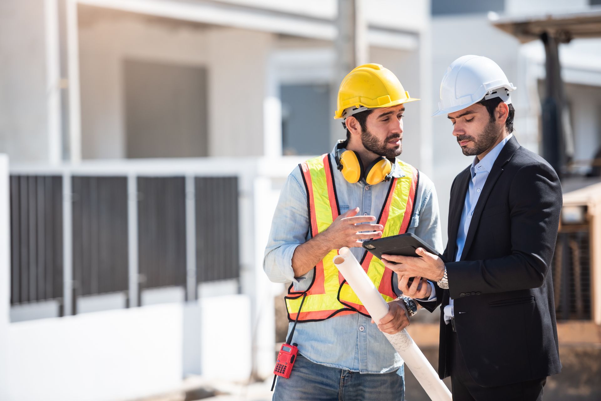Two commercial remodel contractors are looking at plans to renovate a business space.