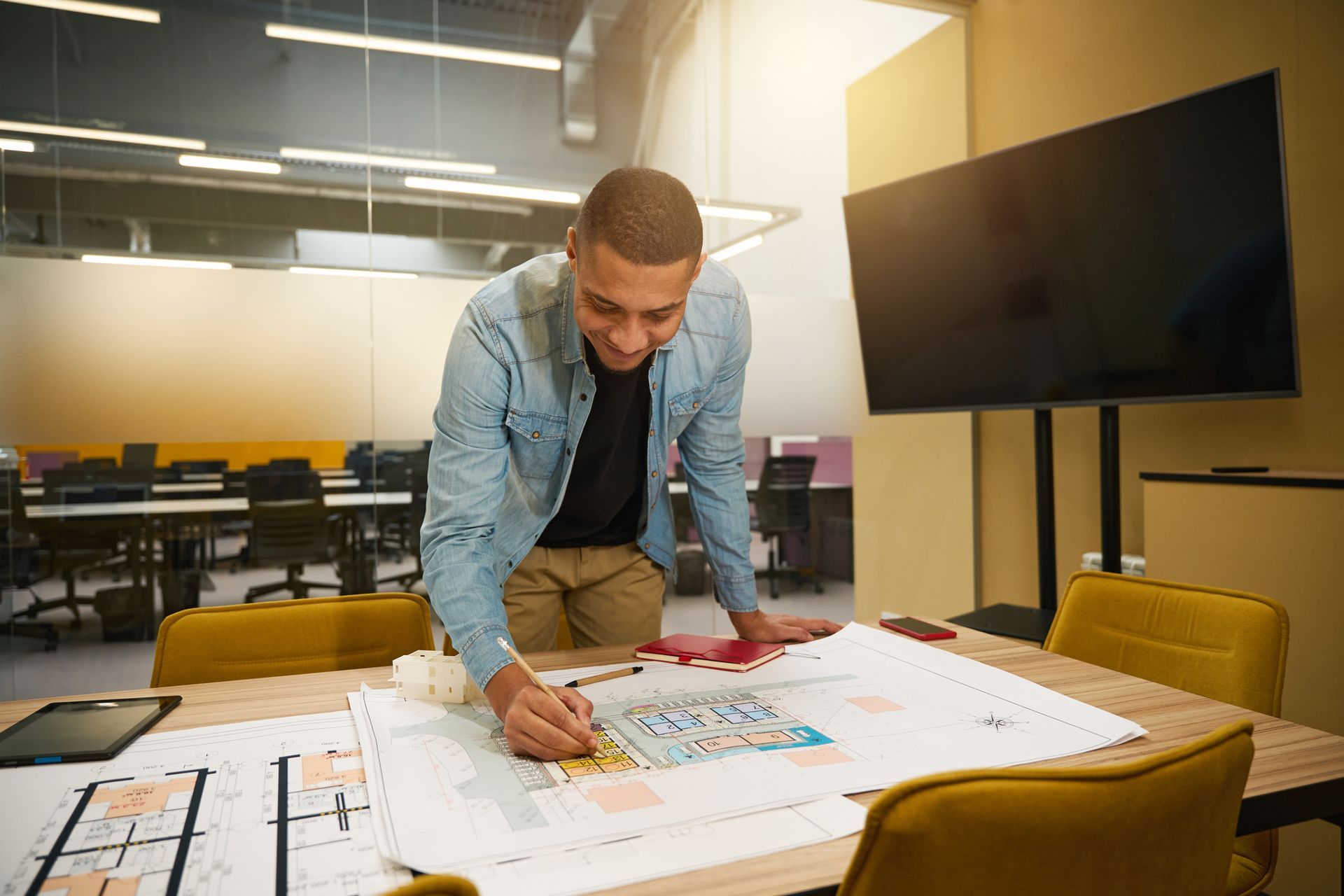 Commercial remodeling contractor finalizing layout plans for commercial office remodel project Commercial remodeling contractor finalizing layout plans for commercial office remodel project