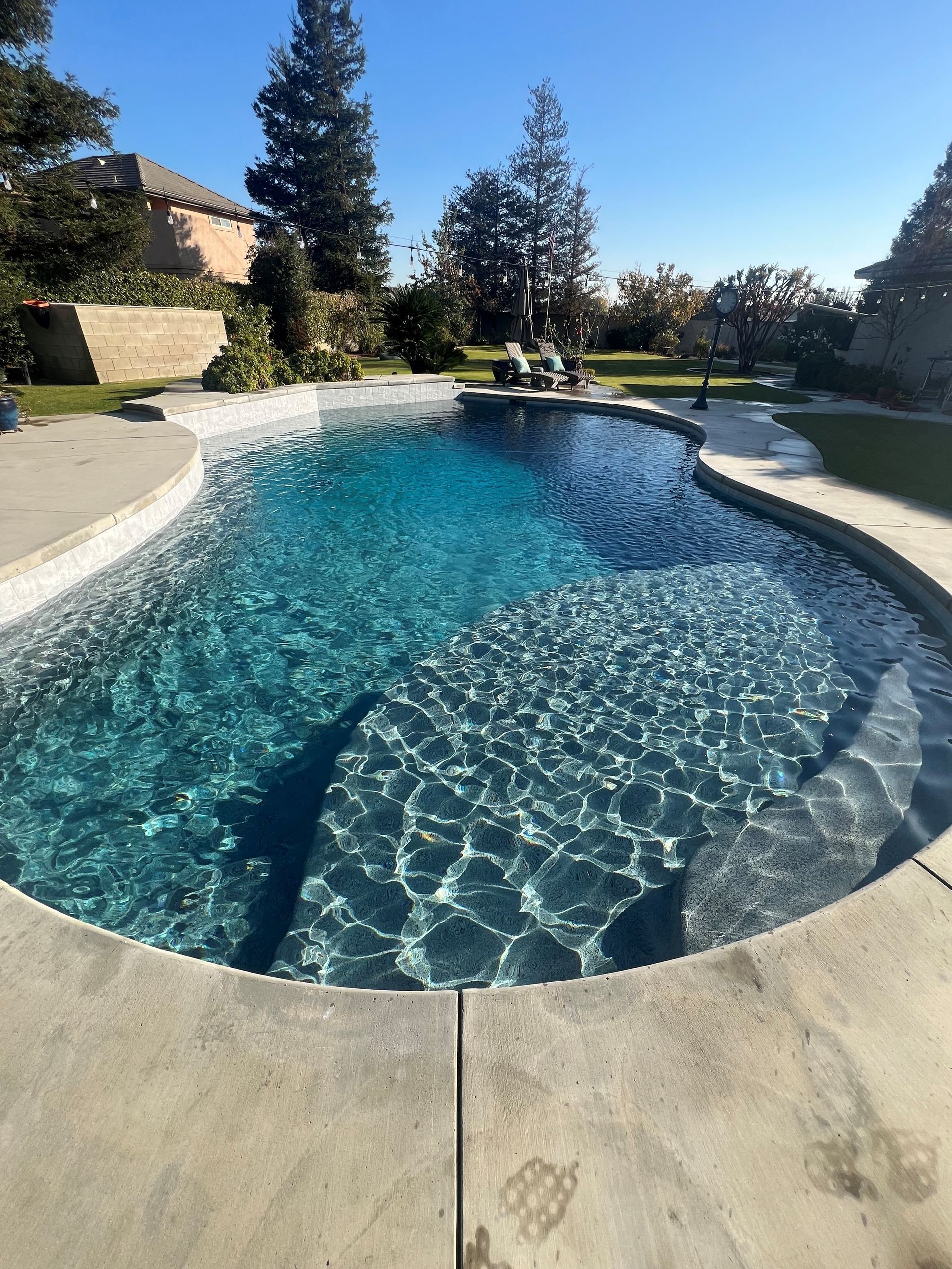 A close up of a swimming pool with a lot of rocks in it.