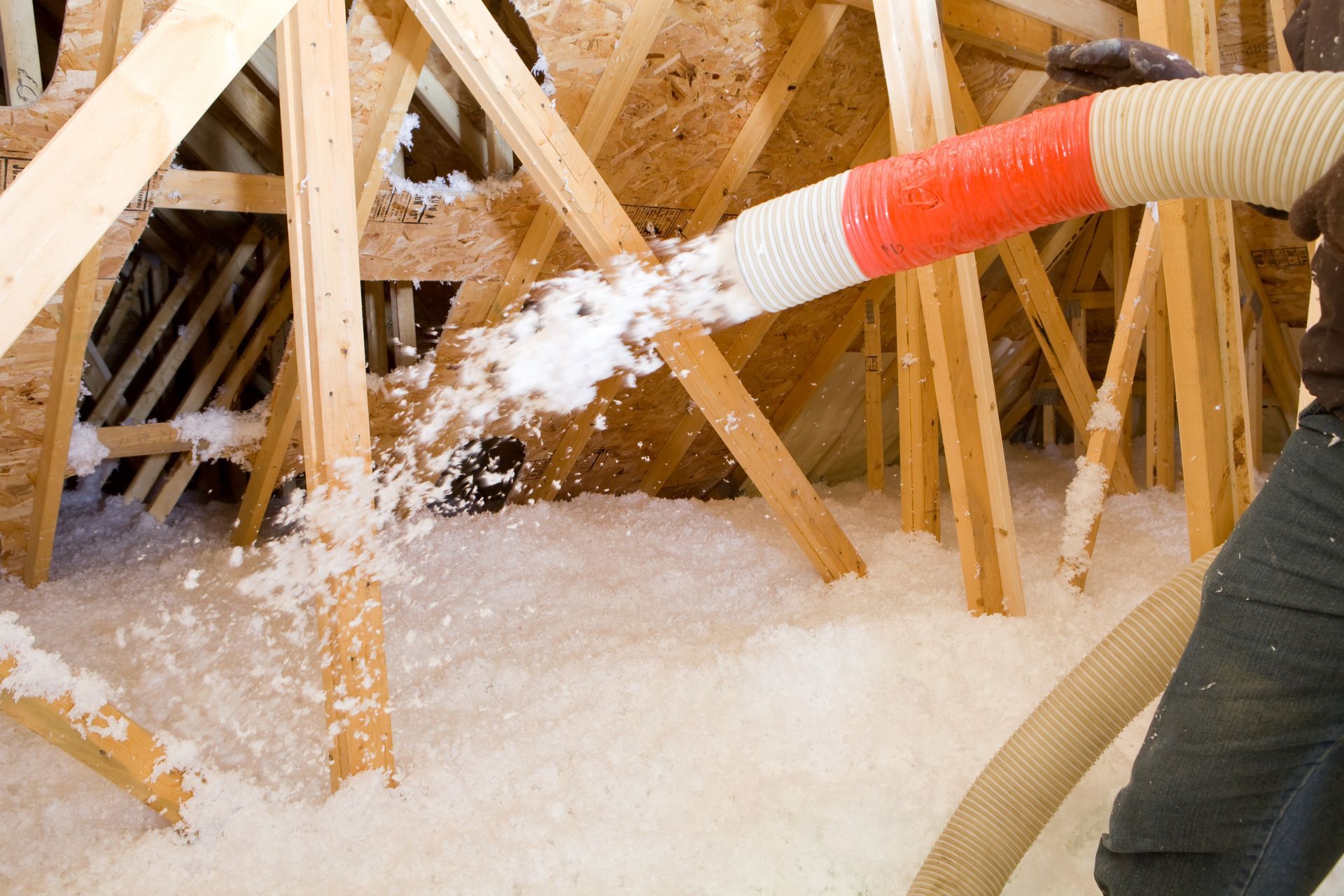 Person Is Blowing Insulation Into the Attic — Nebraska City, NE — Midwest Custom Coatings