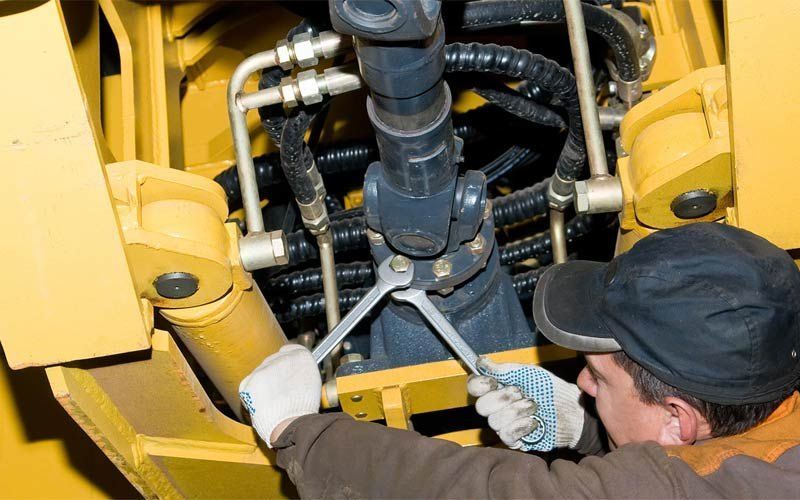 A Mechanic Works on Heavy Machinery — AWE Engineering in South Lismore, NSW
