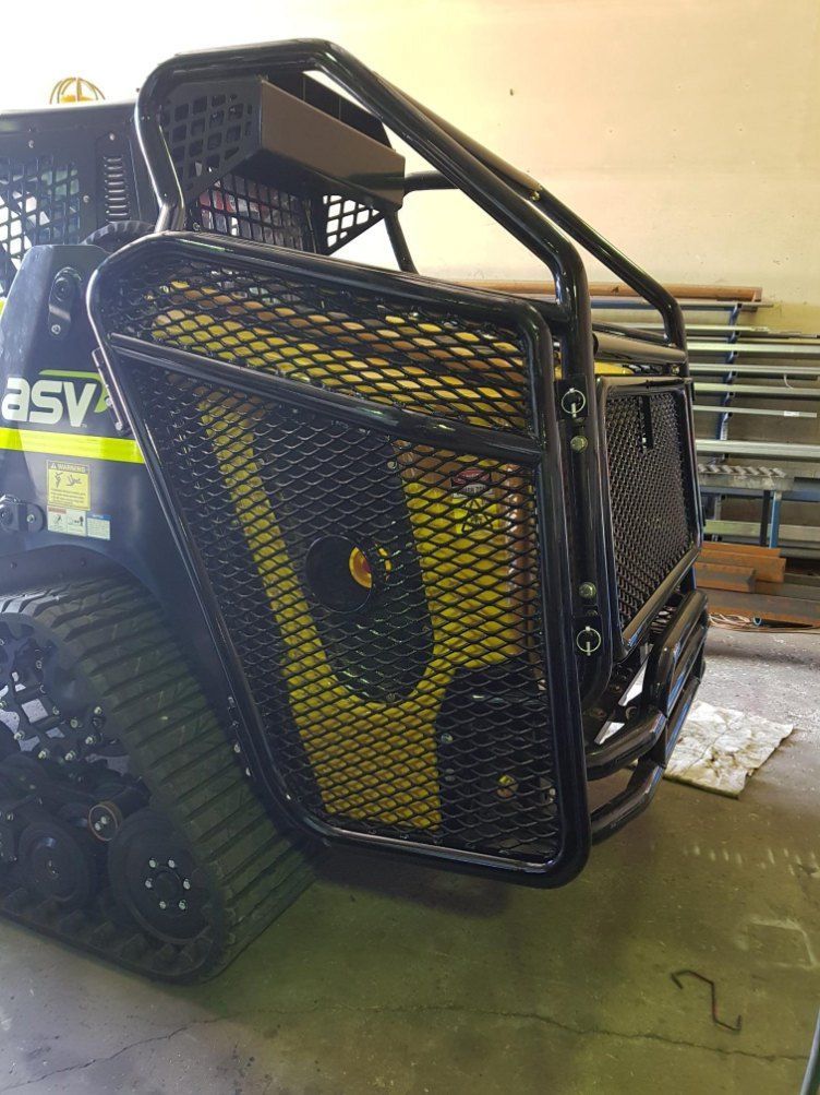 A Black Metal Mesh Guard Protects the Engine of a Yellow Utility Vehicle — AWE Engineering in South Lismore, NSW