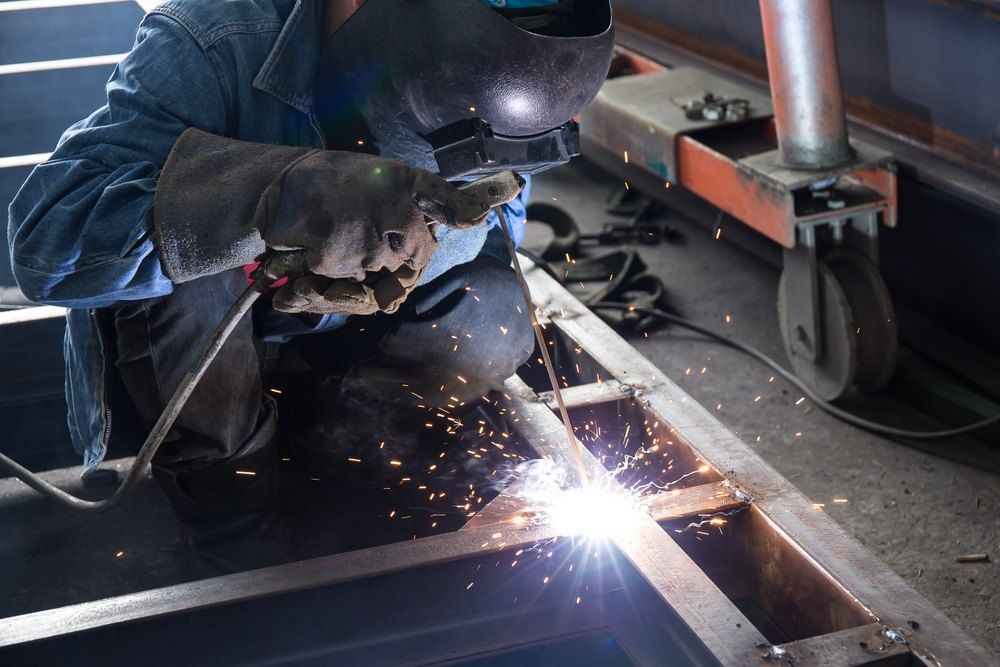 A Welder Works Intensely on a Metal Framework, Sparks Flying — AWE Engineering in South Lismore, NSW
