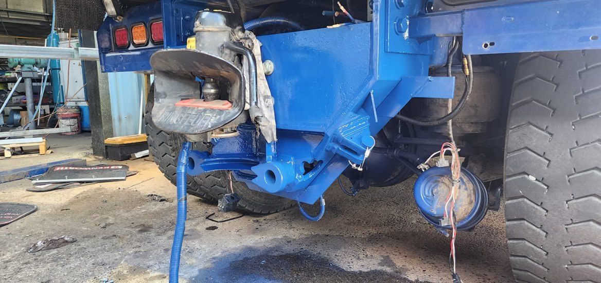 A Heavy Machinery is Undergoing Repairs, With Various Parts and Tools Visible — AWE Engineering in South Lismore, NSW