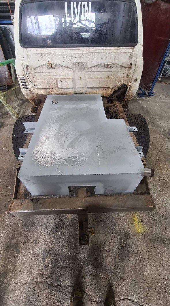 A Light Gray Rectangular Metal Tank Sits on a Dark Surface — AWE Engineering in South Lismore, NSW