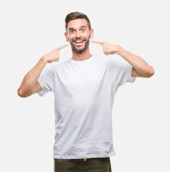 Smiling man in a white T-shirt pointing at himself with both index fingers on a light background