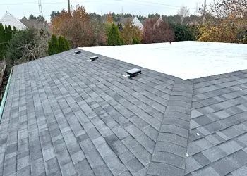 A close up of a roof with shingles and a white roof.