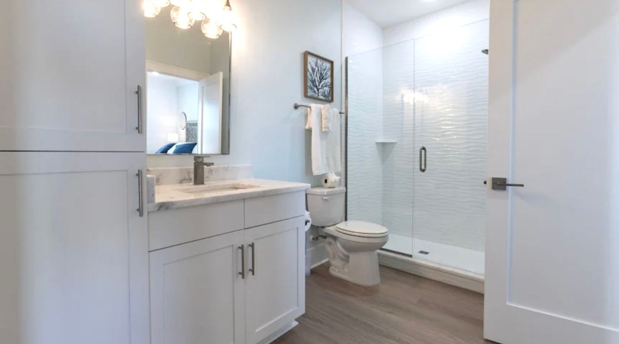 Upstairs King Ensuite with Tile shower & hand held shower wand Private Bath with tile shower adjoining upstairs King size bedroom at rest Ashore in Gulf Shores, Alabama