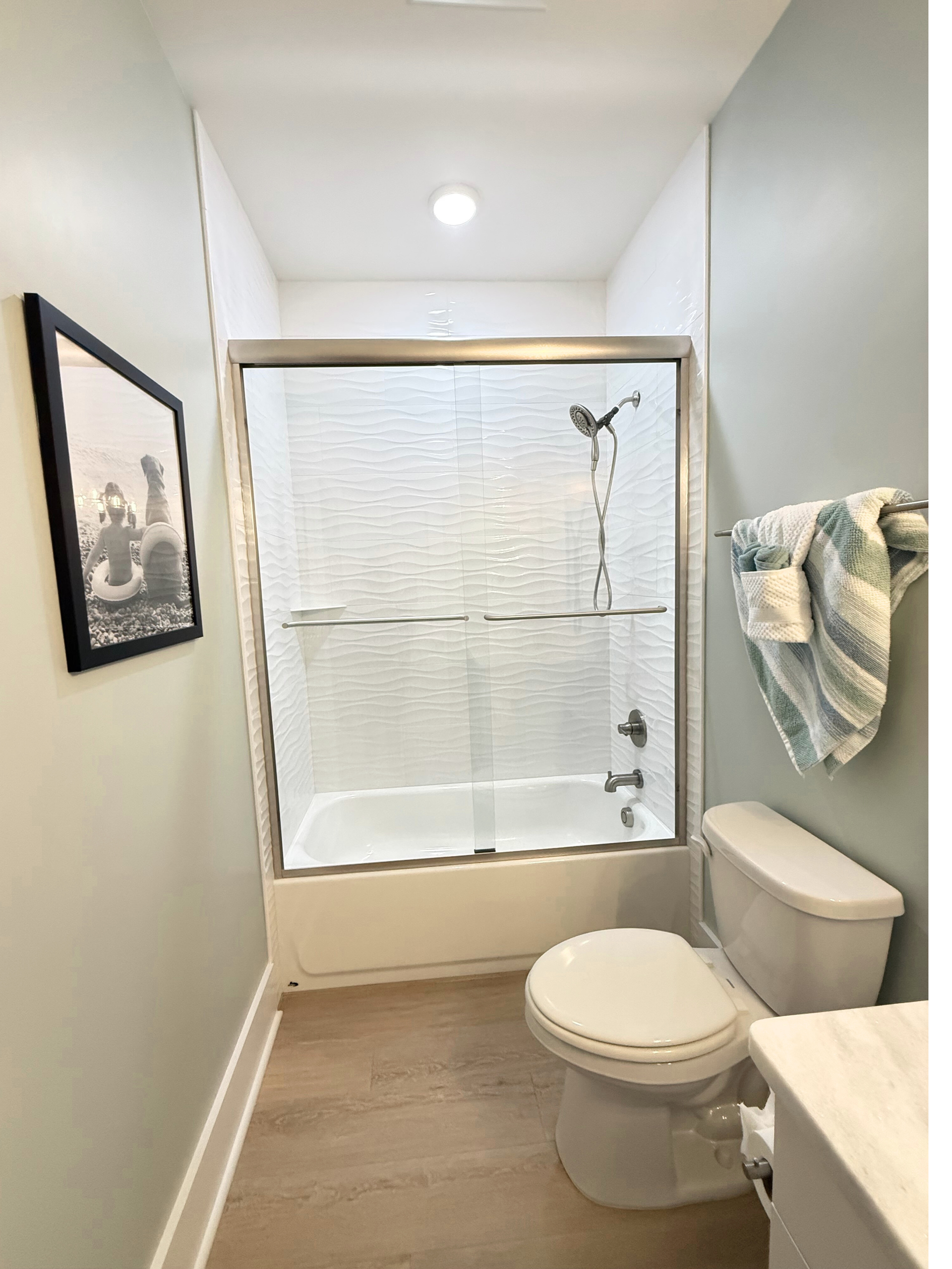 Upstairs Queen Ensuite featuring tub/shower combo & handheld shower wand Tub/shower combo with hand held wand at Rest Ashore in Gulf Shores, Alabama