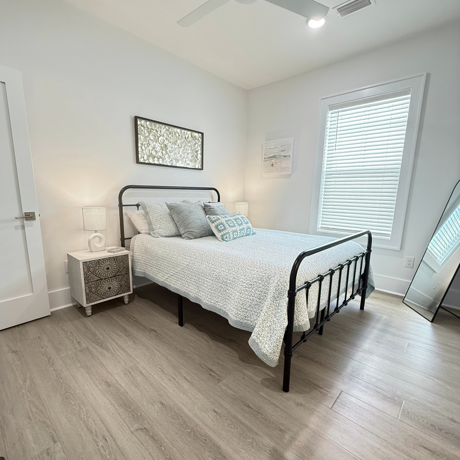 Upstairs Queen Ensuite featuring tub/shower combo & handheld shower wand upstairs queen bedroom with private tub/shower combo at Rest Ashore in Gulf Shores, Alabama