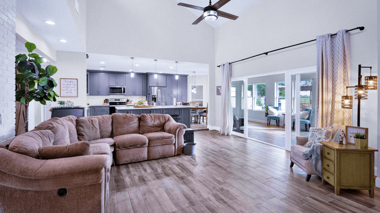 A living room filled with furniture and a ceiling fan.