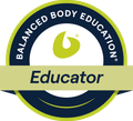 Faint circular logo with a stylized leaf and the words “Balanced Body” in the center