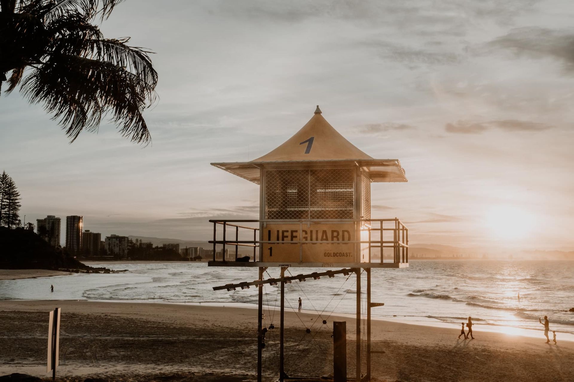 a lifeguard tower on a beach at sunset in Coolangatta