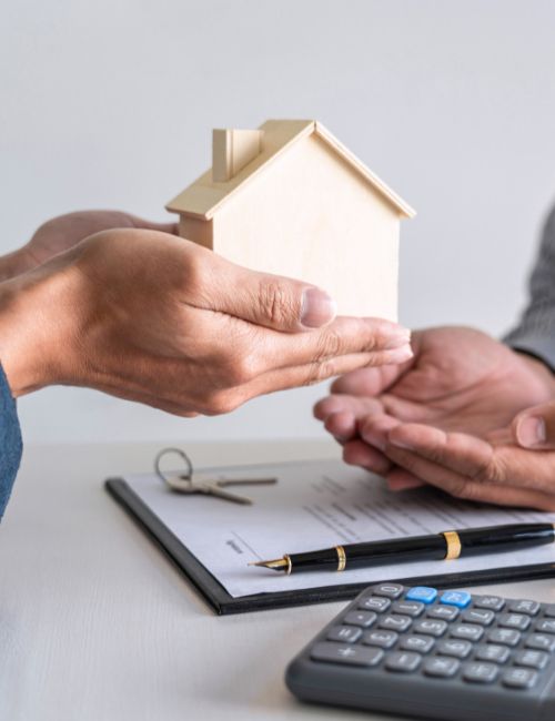 a Coolangatta mortgage broker is holding a model house in their hands