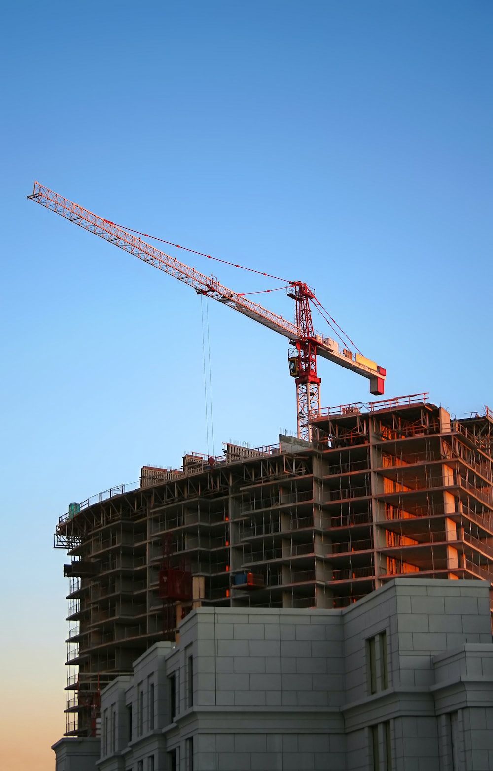 a large building under construction with a crane in the foreground - property development loans