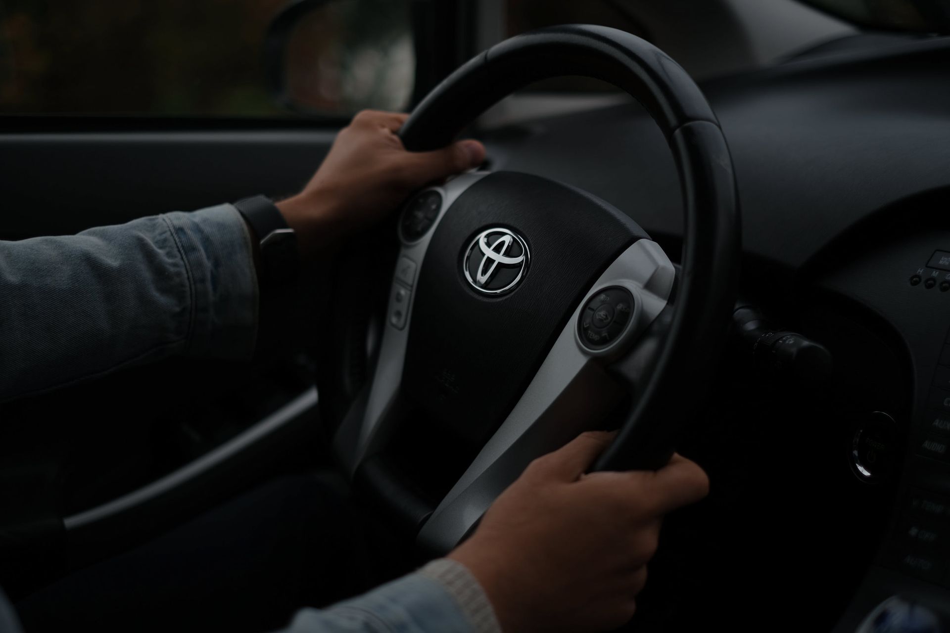 a person is driving a toyota car with their hands on the steering wheel - asset finance
