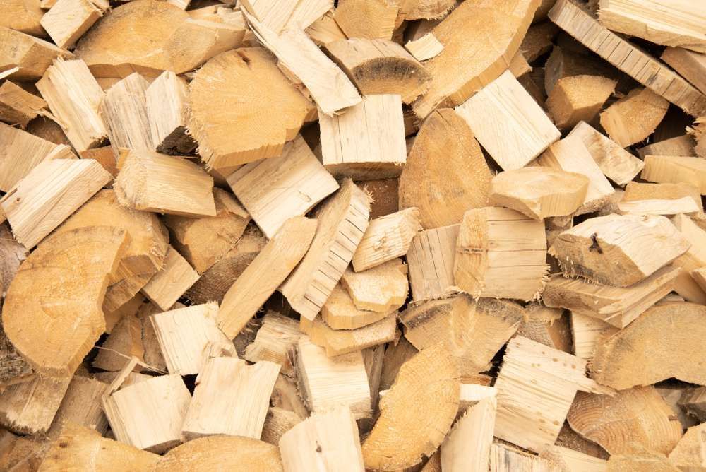 A Pile Of Wood Chips Sitting On Top Of Each Other On A Table — HKL Landscape Supplies in Hallidays Point, NSW