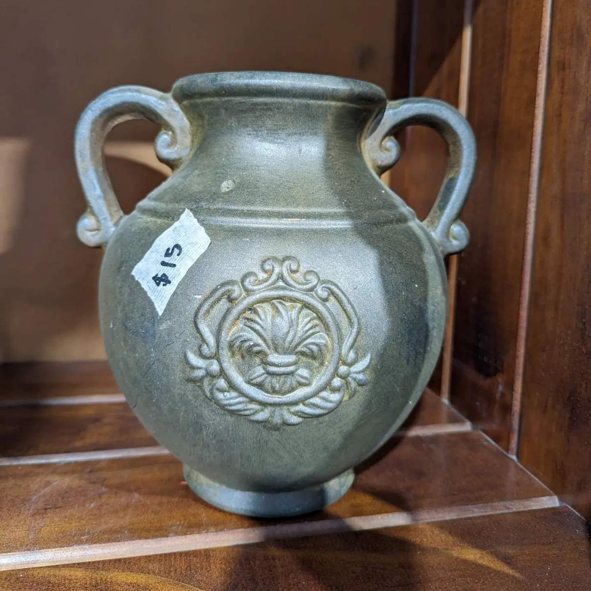 A Vase With Two Handles Is Sitting On A Wooden Shelf — HKL Landscape Supplies in Wingham, NSW
