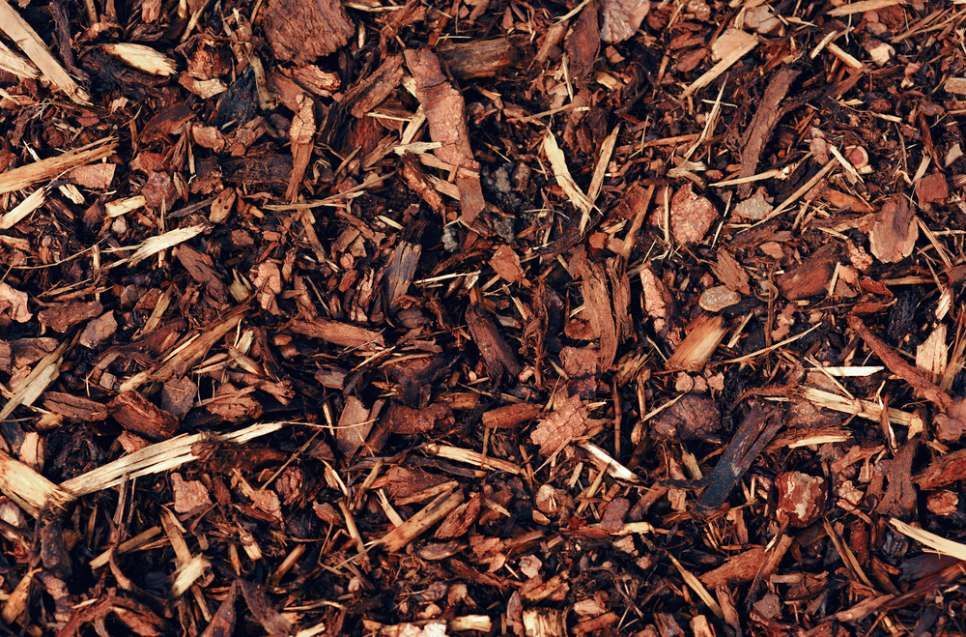A Pile Of Brown Mulch Is Sitting On The Ground — HKL Landscape Supplies in Gloucester, NSW