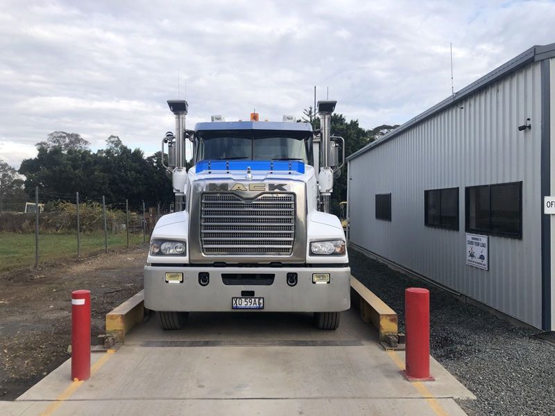 A Large Truck is Sitting on a Scale in Front of a Building — HKL Landscape Supplies in Gloucester, NSW