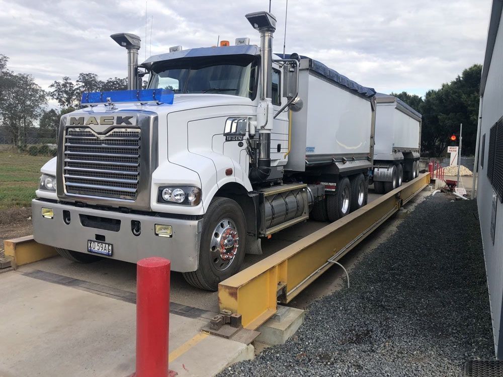 A Large White Truck is Sitting on a Scale — HKL Landscape Supplies in Wingham, NSW