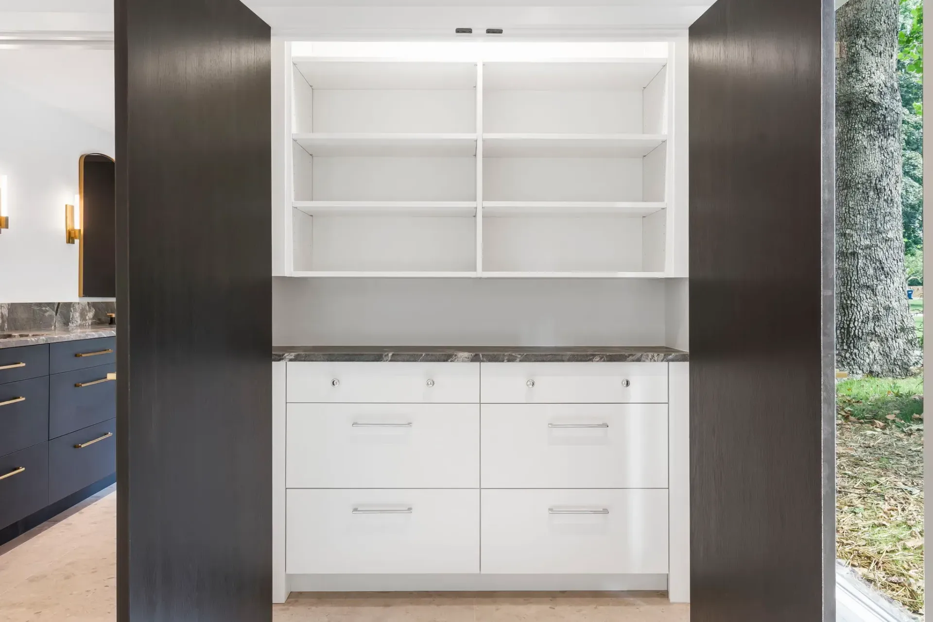 Built-in white cabinetry with open shelves and dark side panels in a modern interior