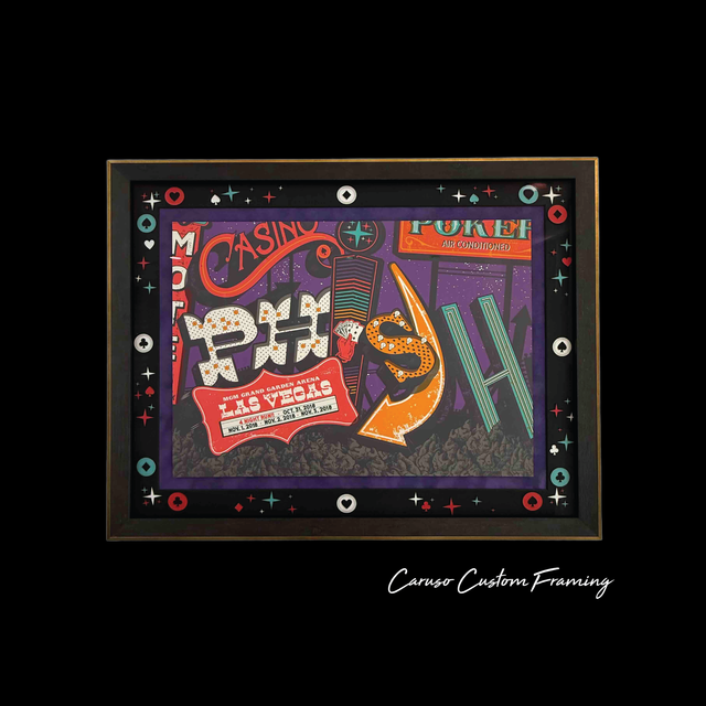 Colorful abstract framed artwork with bold red, orange, green, and purple shapes on black background