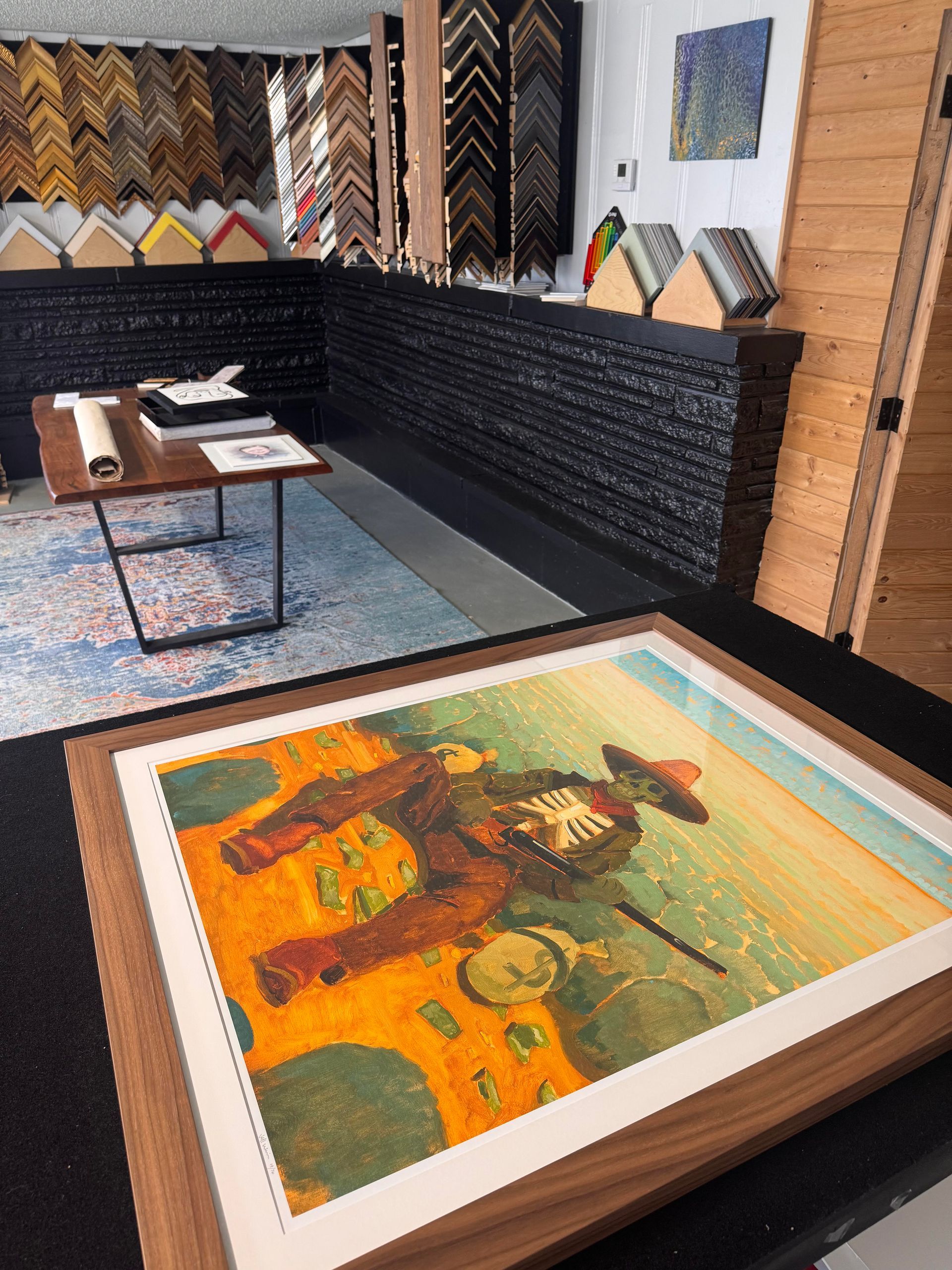 Custom framed cowboy artwork displayed inside a Springfield, MO frame shop.