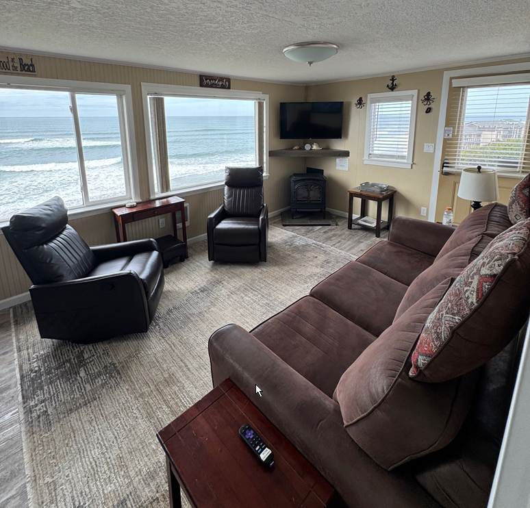 A living room with a couch and two chairs