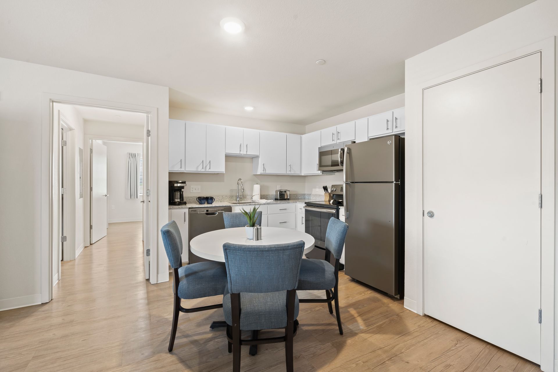 A kitchen with a table and chairs in it