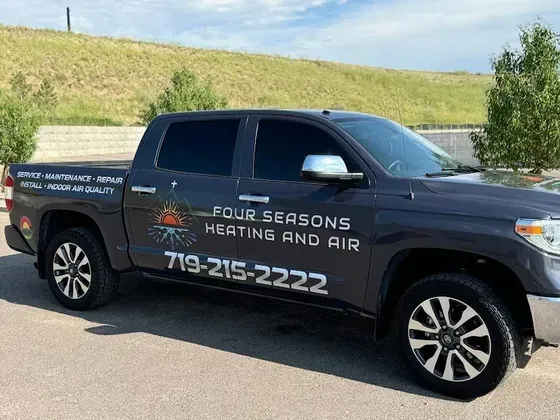 Four Seasons Heating and Air service truck parked in Colorado Springs with company branding and phone number 719-215-2222