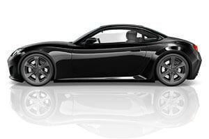 A black sports car is sitting on a white surface with a reflection.
