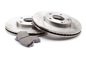 A pair of brake rotors and brake pads on a white background.