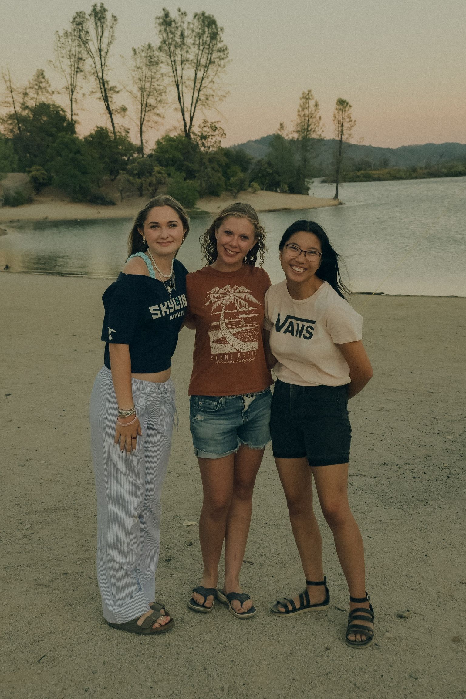 three young adults by the lake