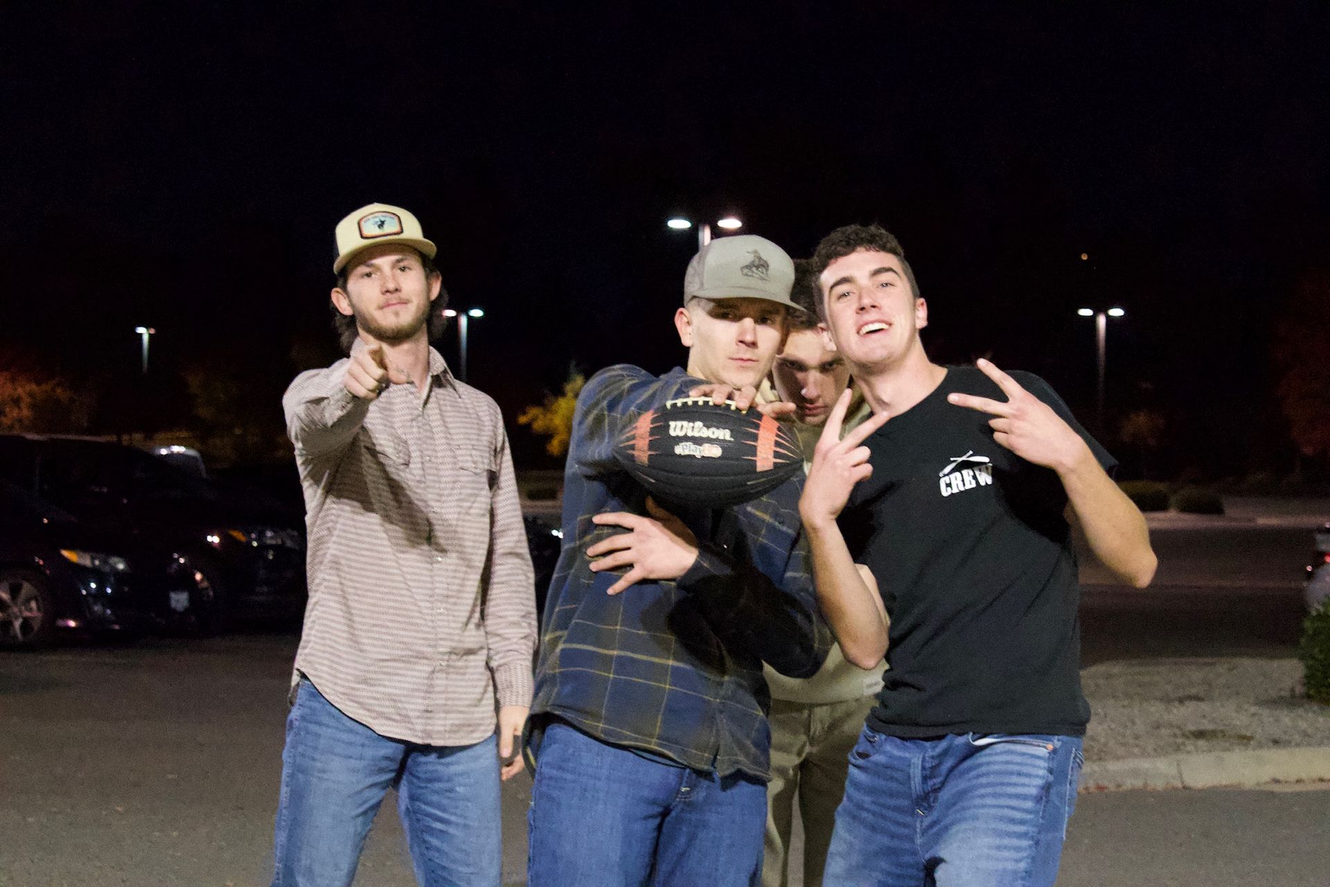 three young adult guys pointing at the camera