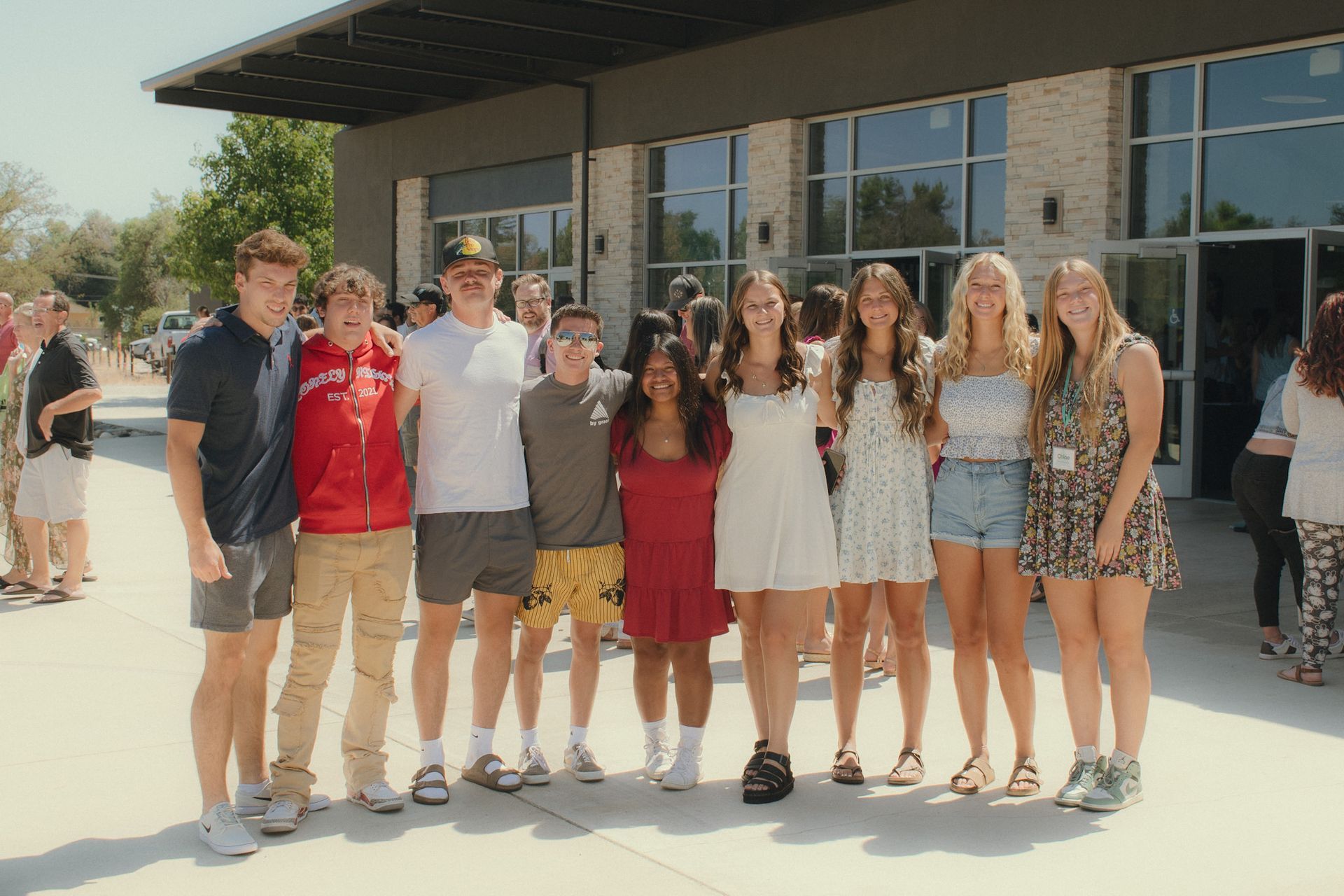 group of young adults smiling outside
