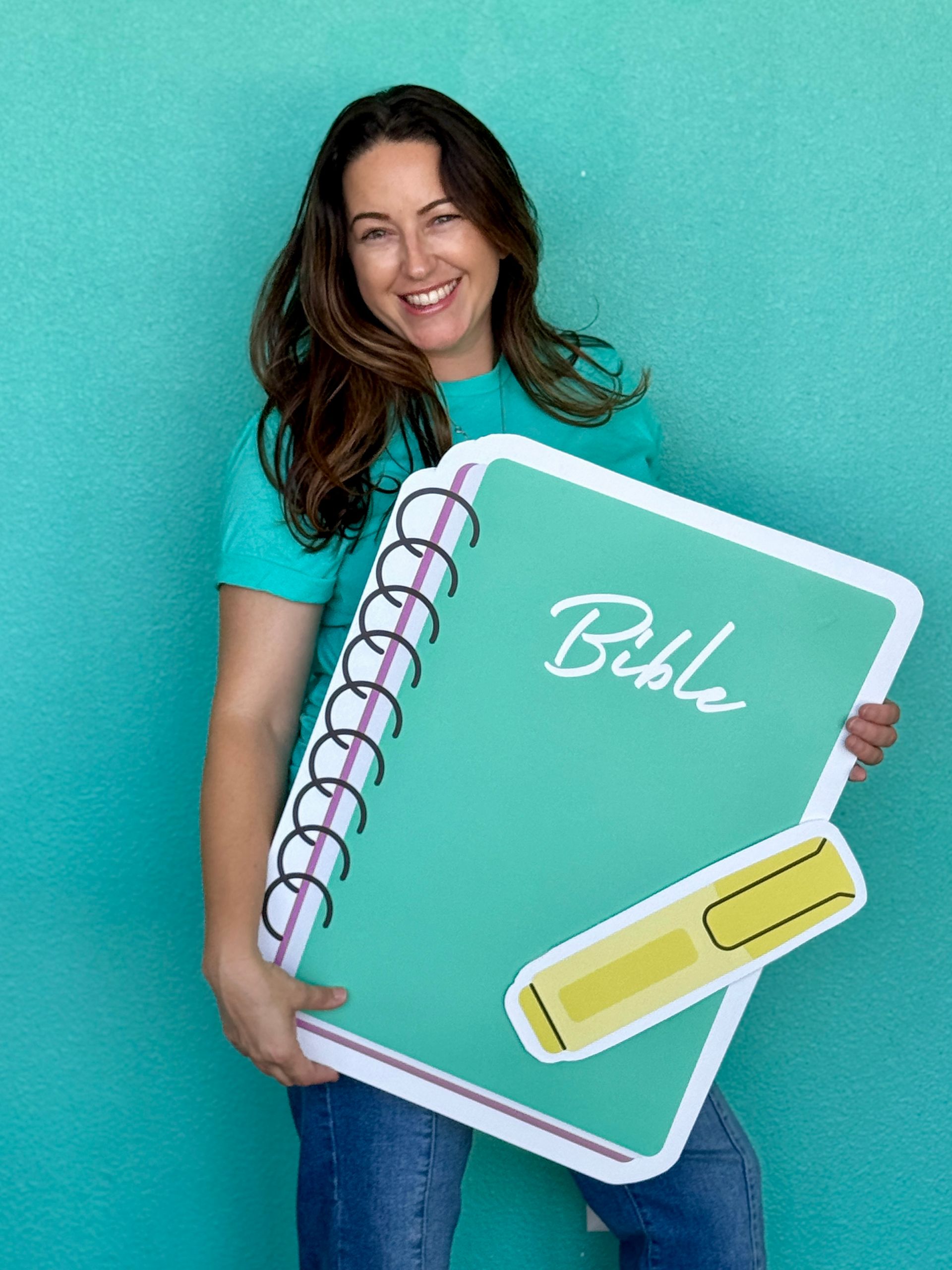 image of adult woman holding a large Bible notebook