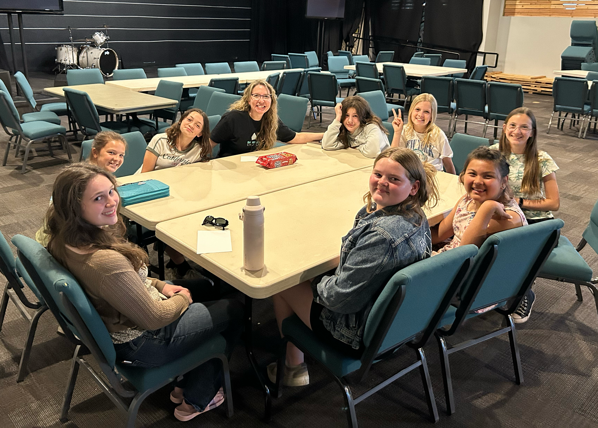 Group of junior high girls sitting around a table.