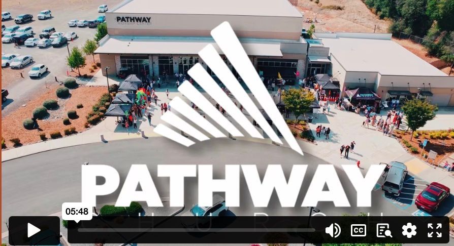 aerial photo of a building with the Pathway fan logo on top